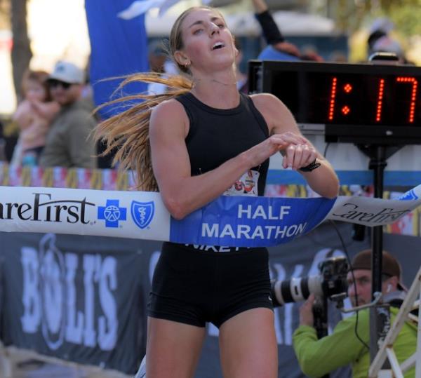 Esther Seeland captures first place in thee women's half marathon during the 24th Annual Running Festival at the inner harbor. (Karl Merton Ferron/Staff)