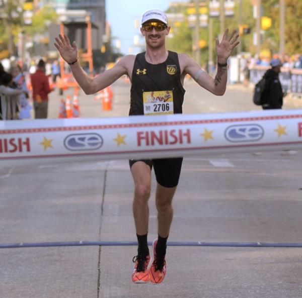 Willy Fink of Gaithersburg reaches the finish line first, capturing the marathon during the 24th Annual Baltimore Running Festival at the Inner Harbor. (Karl Merton Ferron/Staff)