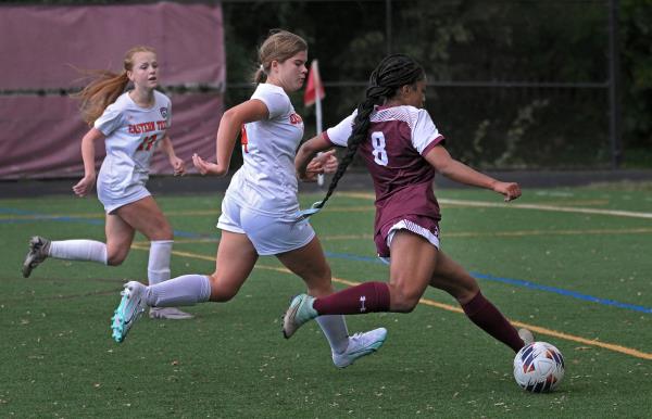 Towson's Tatiyana Chase, right, shoots around Eastern Tech's Cienna Hughes, left, to score in the first half of girls soccer game. (Kenneth K. Lam/Staff)