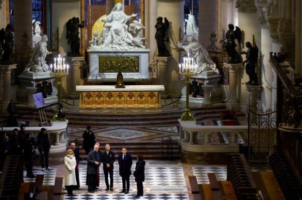 French President Emmanuel Macron, second right, and his wife Brigitte Macron visit the restored interiors of the Notre-Dame de Paris cathedral, Friday, Nov. 29, 2024 in Paris.