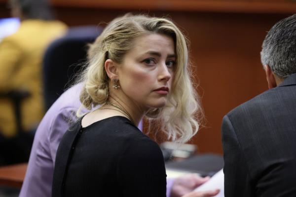 Amber Heard waits before the jury said that they believe she defamed ex-husband Johnny Depp, while announcing split verdicts in favor of both her ex-husband Johnny Depp and Heard .