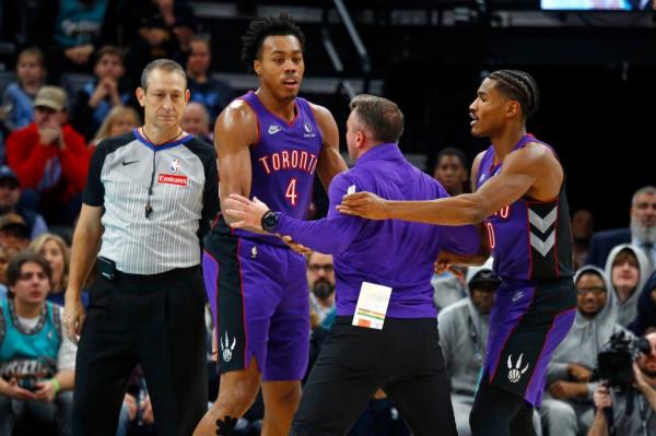 Toro<em></em>nto Raptors head coach Darko Rajakovic (middle) is held back by forward Scottie Barnes (4) and guard Ochai Agbaji (30).