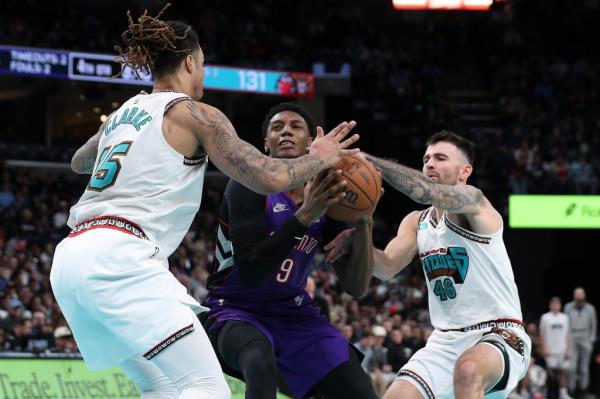 RJ Barrett (9) of the Toro<em></em>nto Raptors drives towards the basket against Brandon Clarke (15) of the Memphis Grizzlies during the second half of their matchup on Thursday evening.