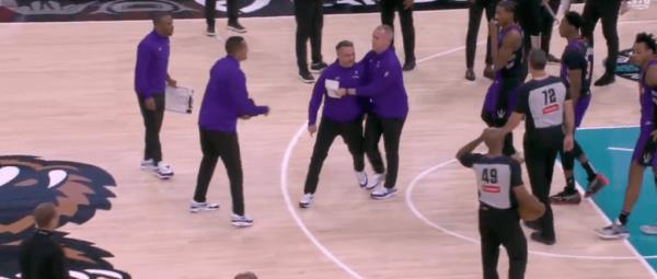 Grizzlies' assistants usher the head coach into the locker room after he's ejected from Thursday night's game.