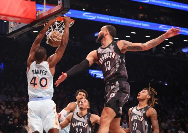 Julian Champagnie of the San Anto<em></em>nio Spurs slams the ball as Tyrese Martin of the Brooklyn Nets is too late to defend during the first half 