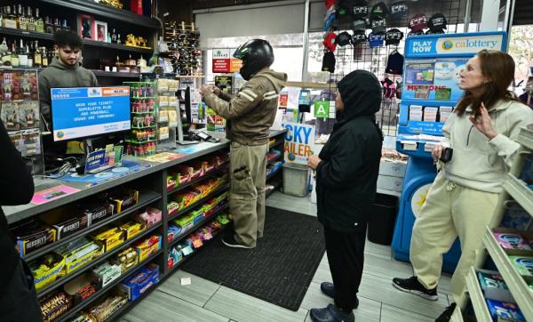 People wait in line to purchase their Mega Millions lottery ticket from a liquor store wher<em></em>e winning tickets have been sold on December 27, 2024.