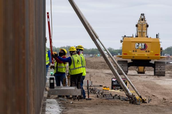 Co<em></em>nstruction crews install panels of the border wall in La Casita-Garciasville, Texas on Nov. 26, 2024.