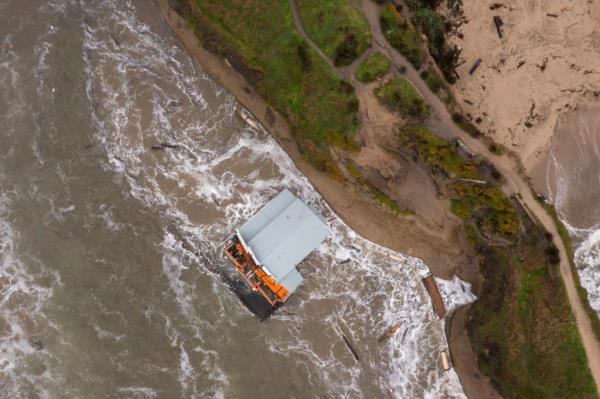 Remnants of a bathroom that fell off the wharf are seen at the mouth of the San Lorenzo River in Santa Cruz, Calif., Tuesday, Dec. 24, 2024.