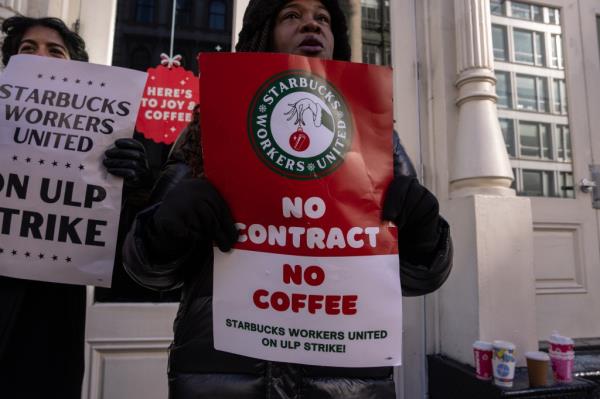 Starbucks baristas picket outside a coffeehouse in New York City on Monday.