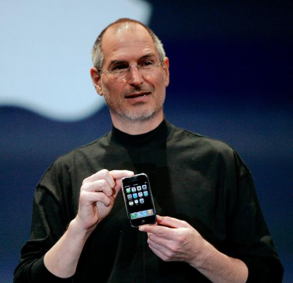 Apple CEO Steve Jobs proudly holding the new iPhone at its unveiling event in San Francisco, California, January 9, 2007