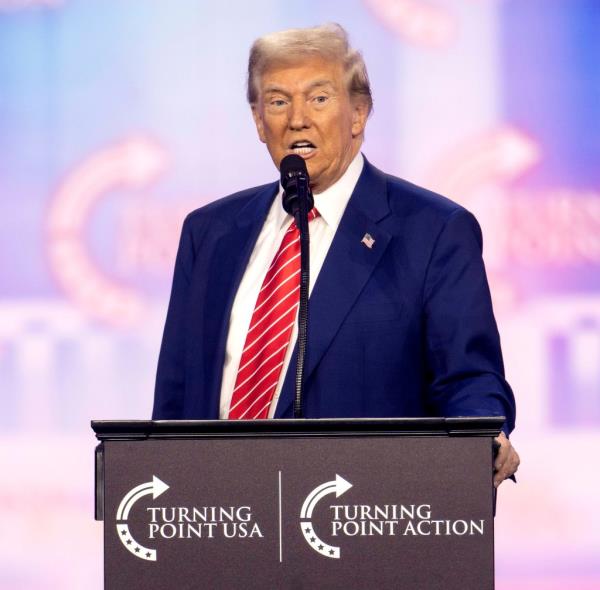 Do<em></em>nald Trump speaking at the podium on day four of Turning Point USA's AmericaFest 2024 in Phoenix, Arizona.