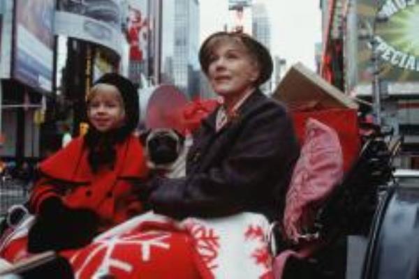 Julie Andrews and Sofia Vassilieva sitting in a carriage filled with Christmas gifts