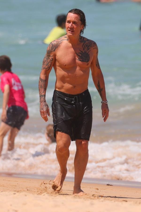 Country superstar Urban showed off his tattoos and his tan.