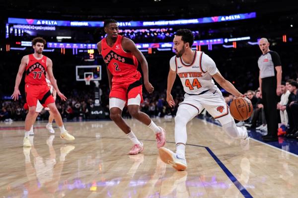 Landry Shamet #44 of the New York Knicks is guarded by Jo<em></em>nathan Mogbo #2 of the Toro<em></em>nto Raptors