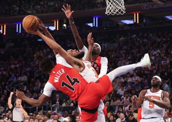 Raptors guard Ja'Kobe Walter (14) fouls New York Knicks center Karl-Anthony Towns (32) during the first half