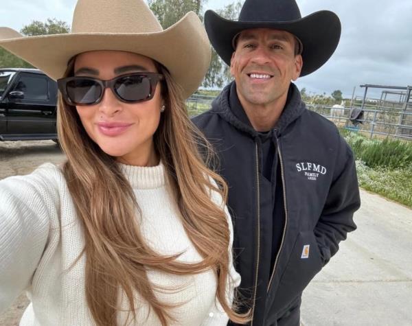 Fitness influencer Miguel Angel Aguilar smiles in a selfie with his wife, Priscilla Valles.