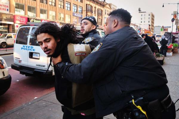 Police officers arresting a man for fare evasion and resisting arrest at the 149th Street station in The Hub on Dec. 13, 2024.