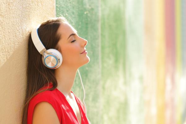 A woman listening to music with headphones