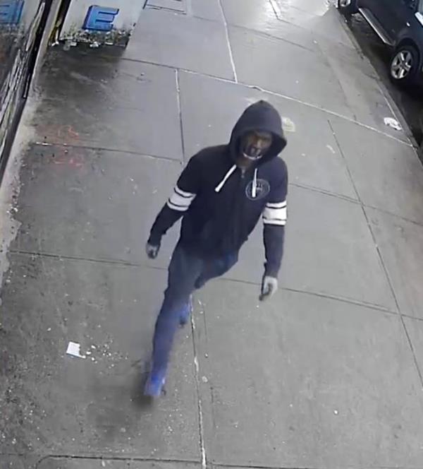 surveillance image released by NYPD that show a man wearing a hooded sweatshirt and black surgical mask on the sidewalk. He is the suspect in four separate groping incidents in Jamaica, Queens, Mo<em></em>nday morning. 