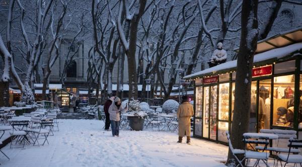 Snow falls in Bryant Park in midtown Manhattan on Dec 21