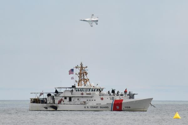 an F-16 falcon from the U.S. Air Force Thunderbirds flies over the Coast Guard cutter Bruckenthal on  31 May 2021 in New York, US.  