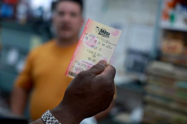 A person holding a Mega Millions ticket 