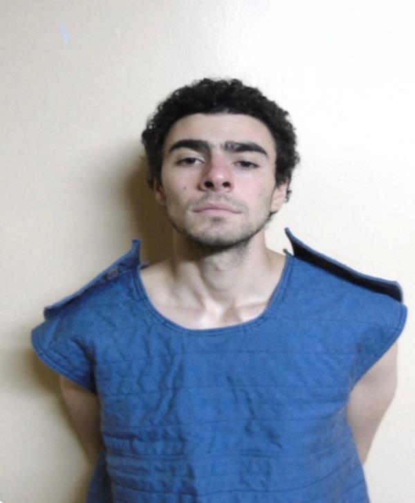 Luigi Mangione in his booking photo from the Pennsylvania Department of Corrections, dressed in a blue shirt, after being charged with the murder of Brian Thompson