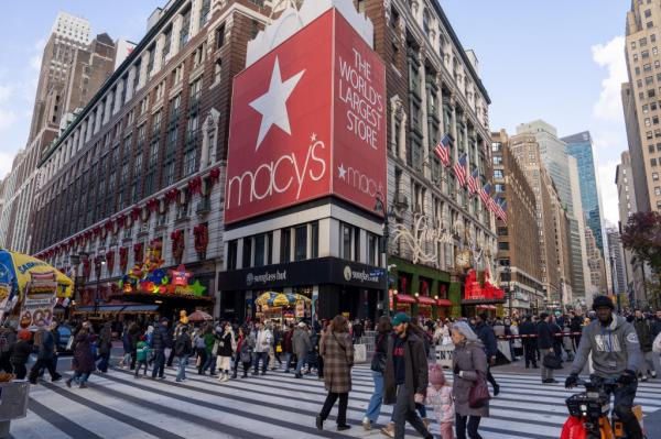 People walking past Macy's Herald Square flagship store during Black Friday sales in New York City, November 29, 2024