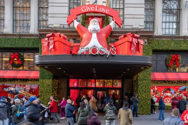 People walking past Macy's Herald Square flagship store during Black Friday sales in New York City, 2024