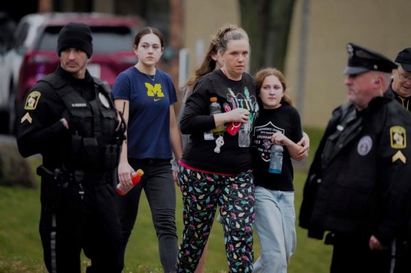 A family leaves the shelter following a shooting at the Abundant Life Christian School, on Dec. 16, 2024.