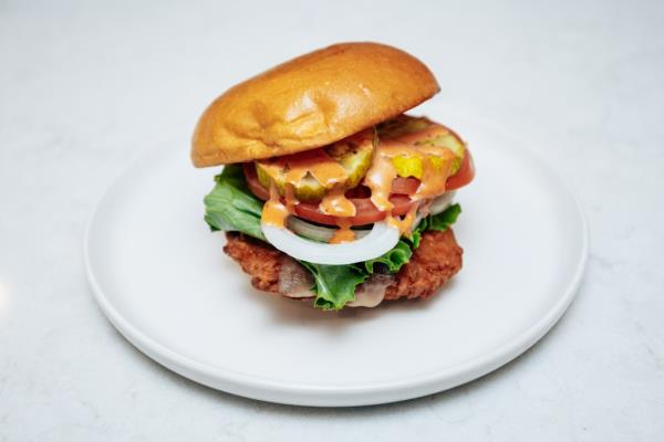 Mas Spicy Fried Chicken Sandwich Deluxe on a plate from Streetbird by Marcus Samuelsson, Manhattan, photographed on December 10, 2024.