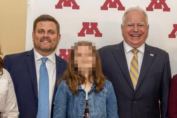 UnitedHealthcare CEO Brian Thompson and Minnesota Governor Tim Walz smiling and standing in front of a white wall with red letters for an announcement a<em></em>bout the Special Olympics in 2022.