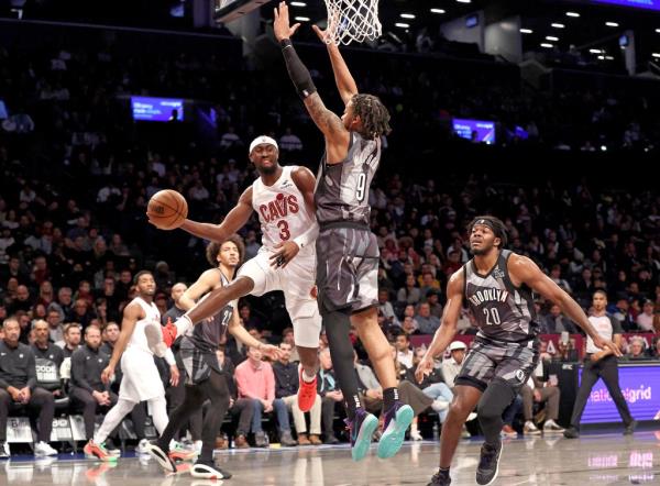 Trendon Watford #9 of the Brooklyn Nets jumps to defend as Caris LeVert of the Cleveland Cavaliers makes a jumping pass during the first quarter on Dec. 16, 2024,