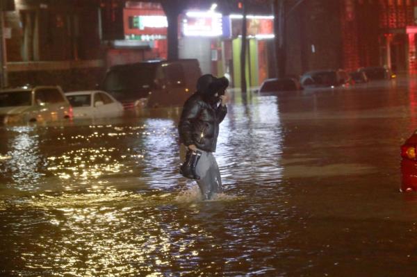 Person walking through water up to their knees 