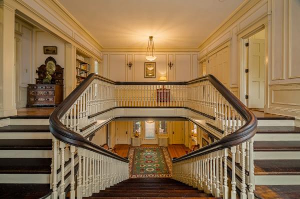 Grand stairs add a touch of old world drama to the home