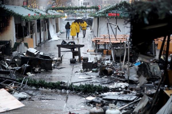 Firefighters work at the scene of a fire at the Christmas Market in Herald Square on Broadway and 35th St early Monday, Dec. 16, 2024.