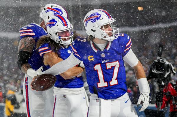 Bills Quarterback Josh Allen celebrates a touchdown in the snow.