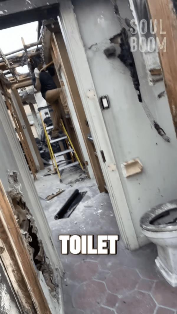 Rainn Wilson showing the charred toilet in his house after the fire.