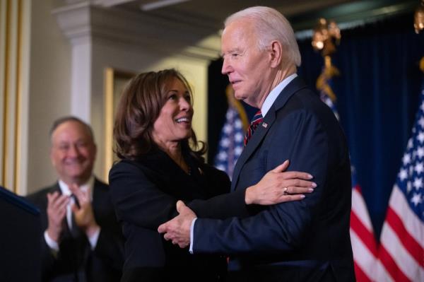 US Vice President Kamala Harris embracing US President Joe Biden at the Democratic Natio<em></em>nal Committee's Holiday Reception in Washington, DC, on December 15, 2024